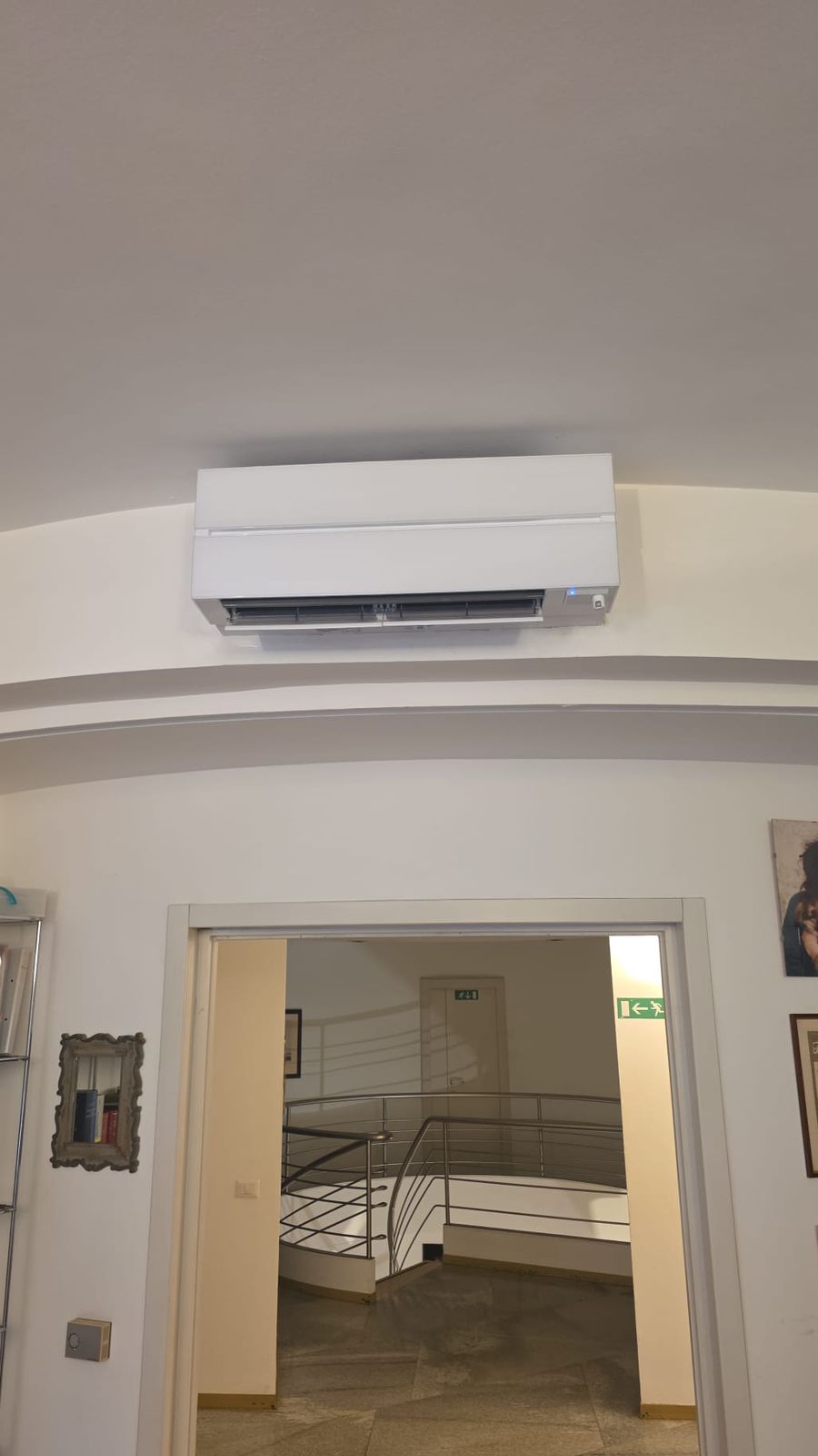 Climatizzatore split a parete installato sopra una porta in un ufficio
